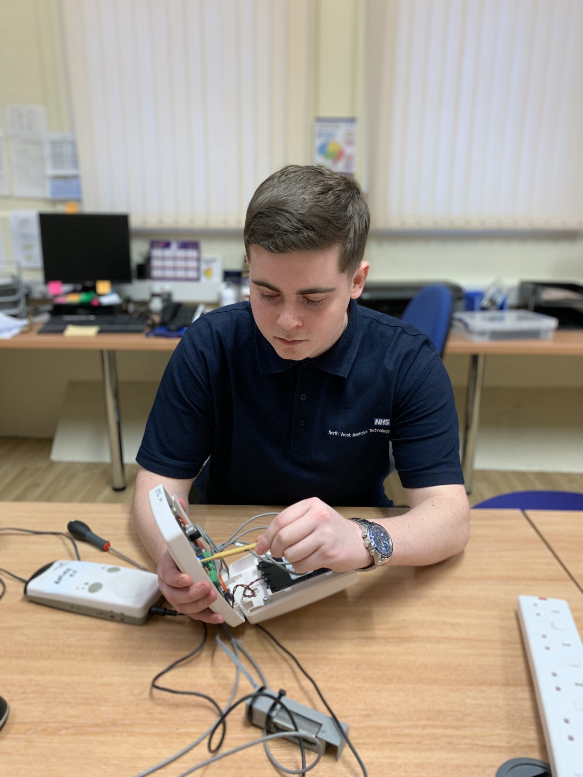 Young male working on medical equipment in workshop