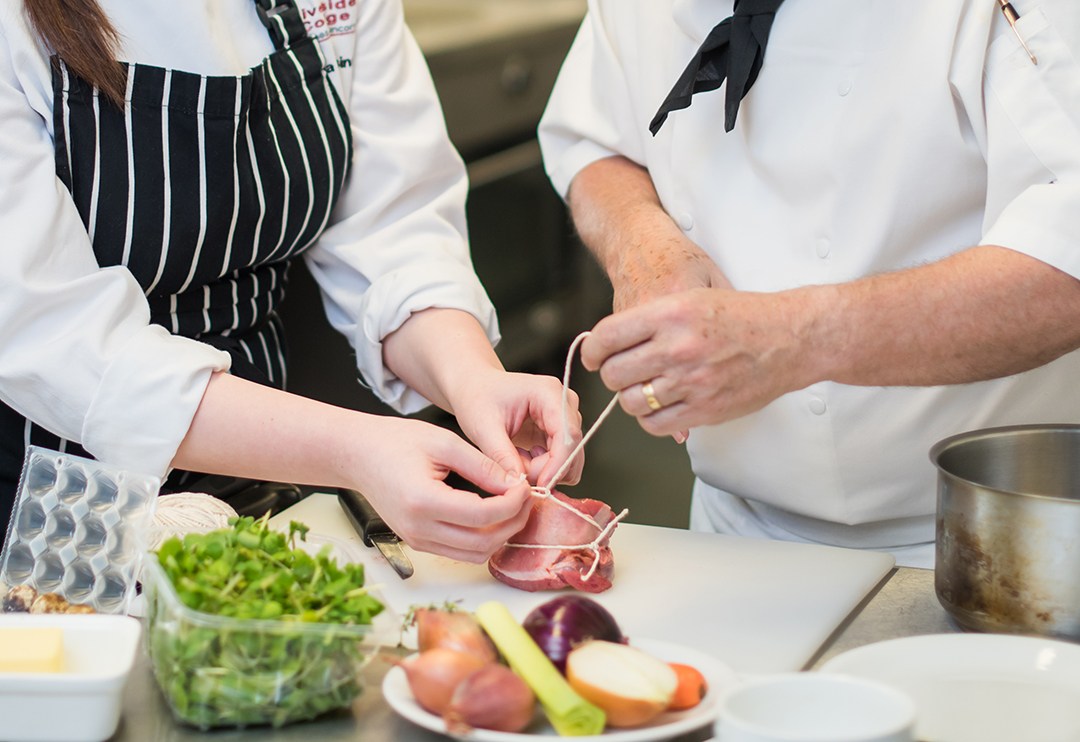 Chefs preparing meat