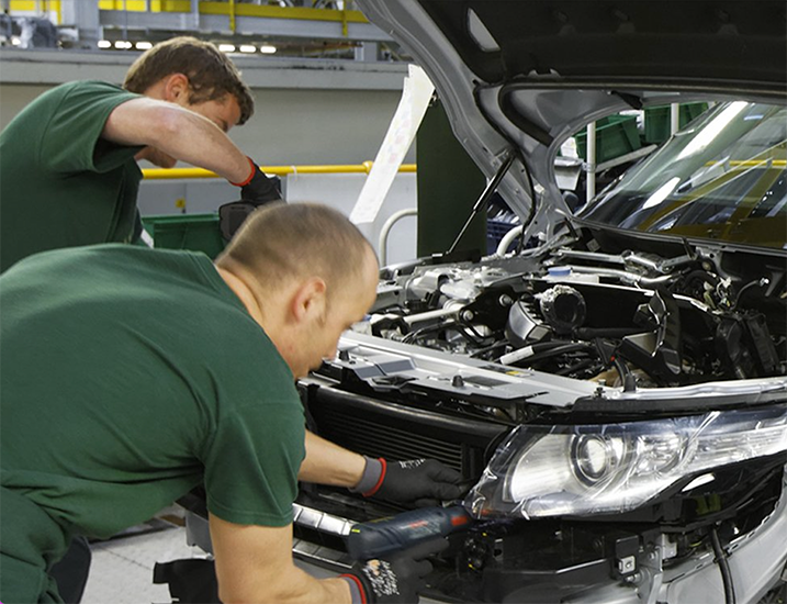 Male engineers constructing a car