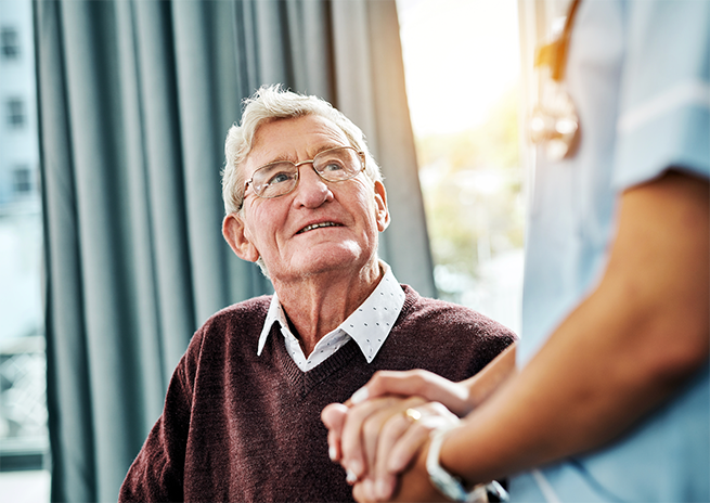 Elderly man with grey hair receiving health care