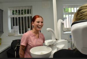 Dental nurse smiling in surgery