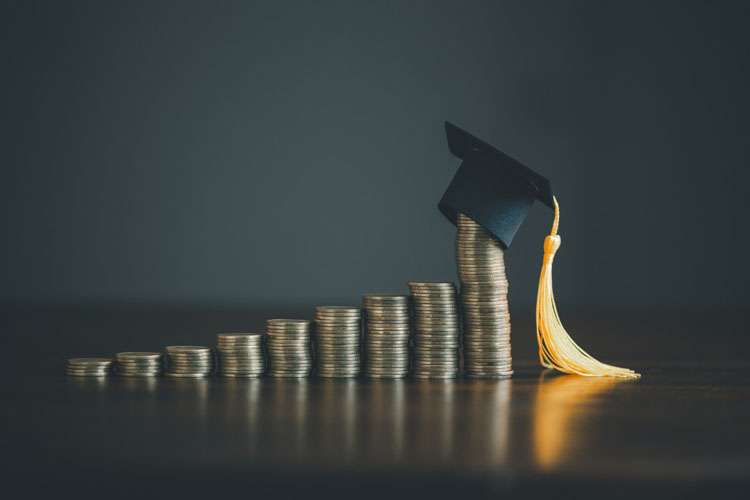 Stacks of coins with mortarboard