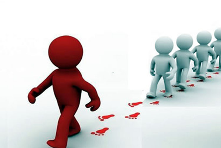 A line of people following the footsteps of the person leading the line