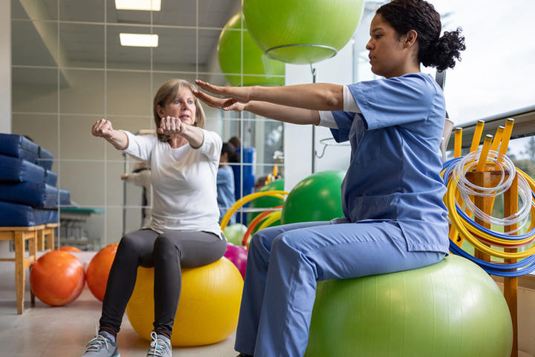 Female occupational therapist working with female patient