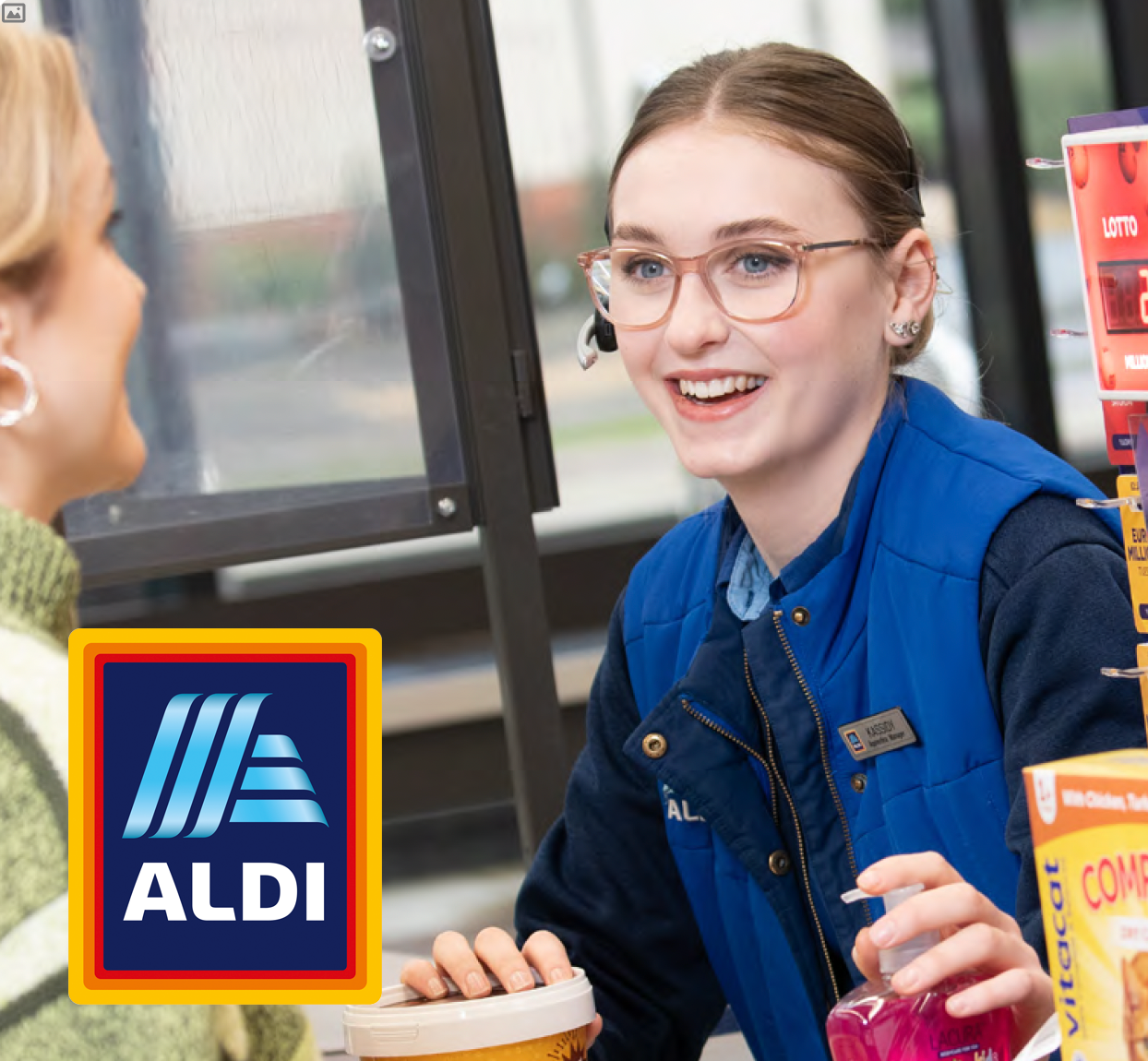 Young female serving customer in supermarket
