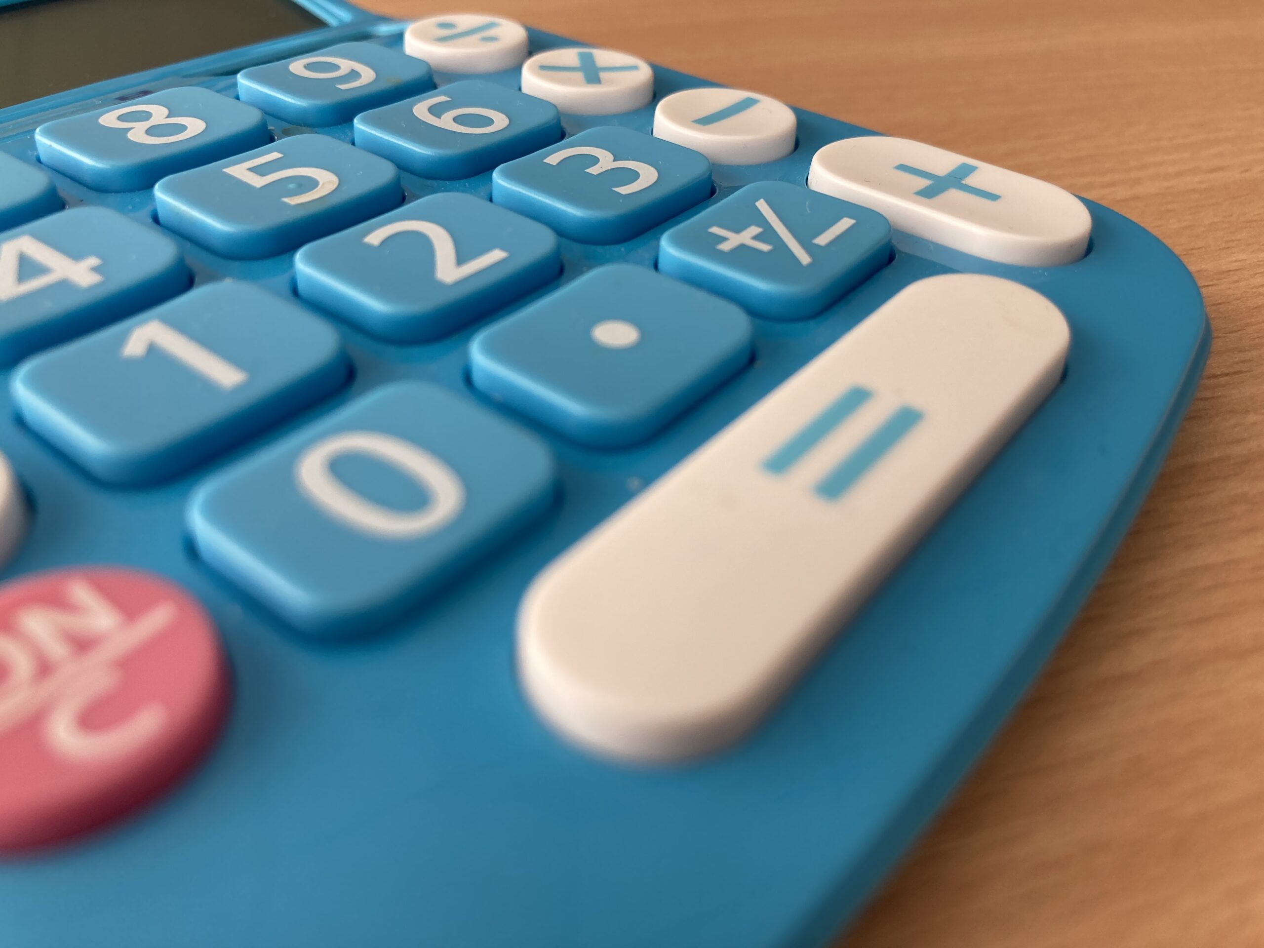 Image of blue electronic calculator with white text on buttons