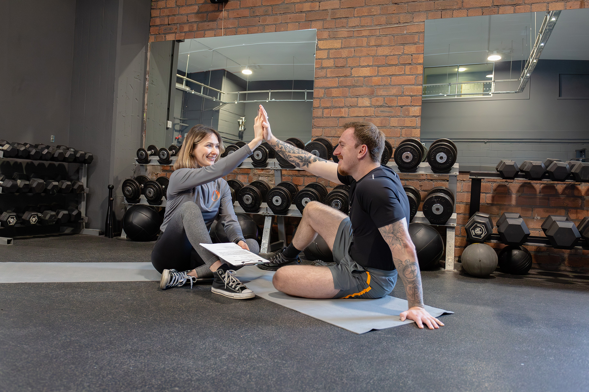 Male and female taking part in gym activities in gym